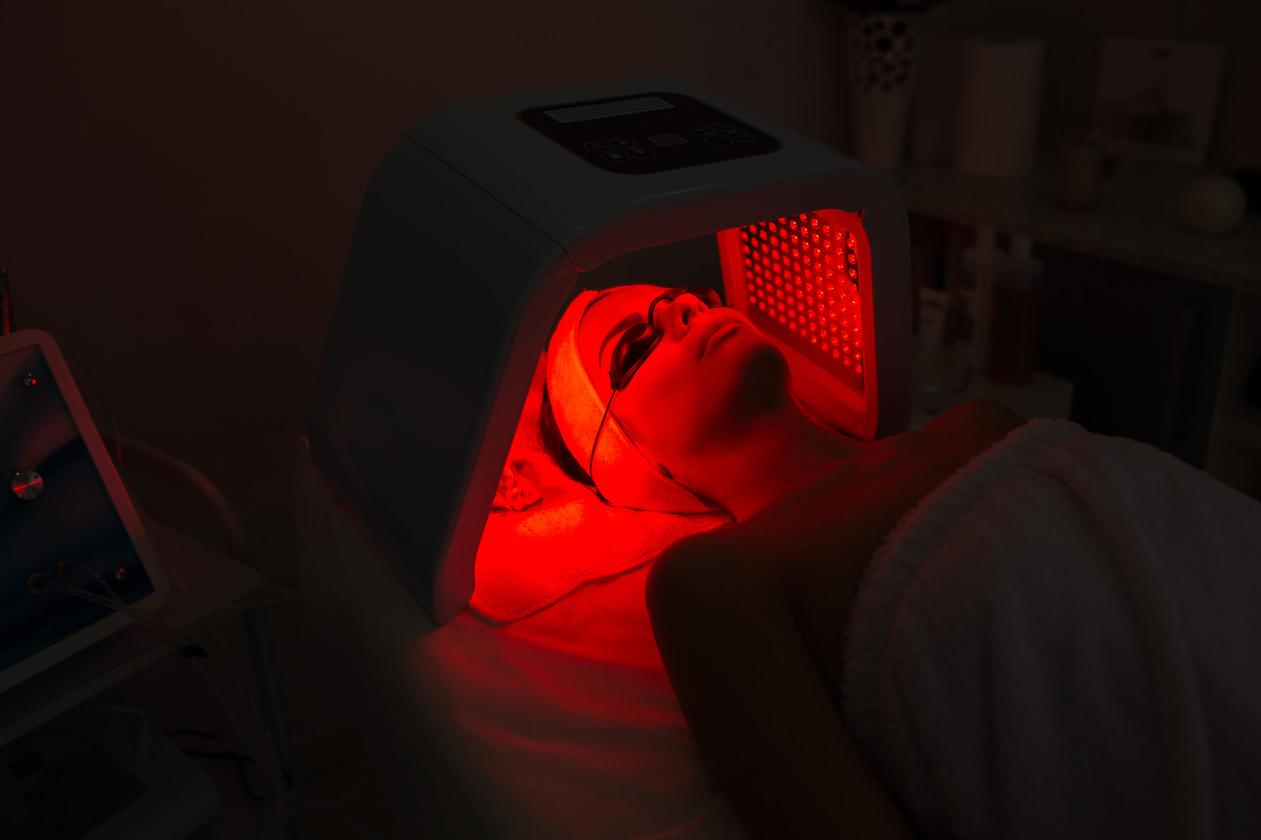 A therapist applying treatment product to a client's face during a facial.